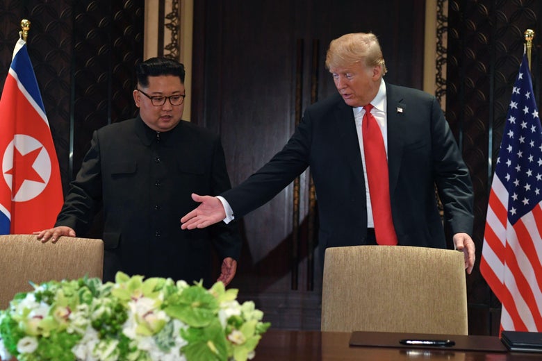 U.S. President Donald Trump gestures as he and North Korea's leader Kim Jong Un arrive for a signing ceremony during their historic summit in Singapore on June 12, 2018.